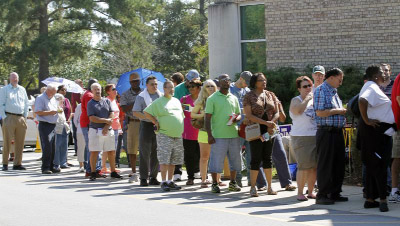 The line wraps around the corner of the building as hundreds of voters came out on the first day of early voting at the Hope Mills Recreation Center in Hope Mills, NC on Thursday.