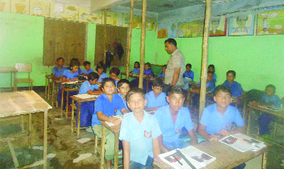 JHENAIDAH: Both students and teachers attending classes at risky Chapali Government Primary School as the beams of the building are supported by bamboo. This picture was taken on Friday.