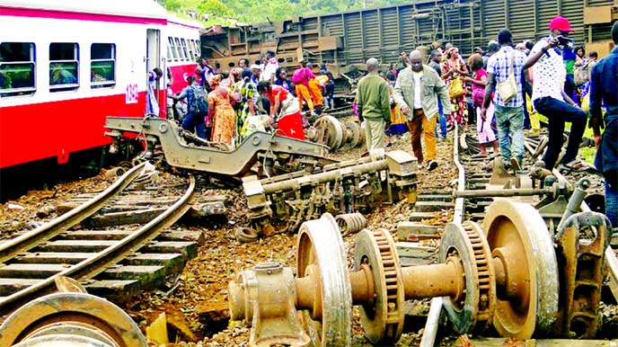 Passengers escape the site of a train derailment in Eseka, Cameroon, Friday. The death toll in the crash rose to more than 70 people Saturday.