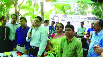 SAGHATA (GAIBANDHA): Ataur Rahman, Officer-in- Charge , GRP Thana distributing leaflets to buildup awareness on rail accidents at Bonarpara Rail Station in Saghata Upazila on Saturday.