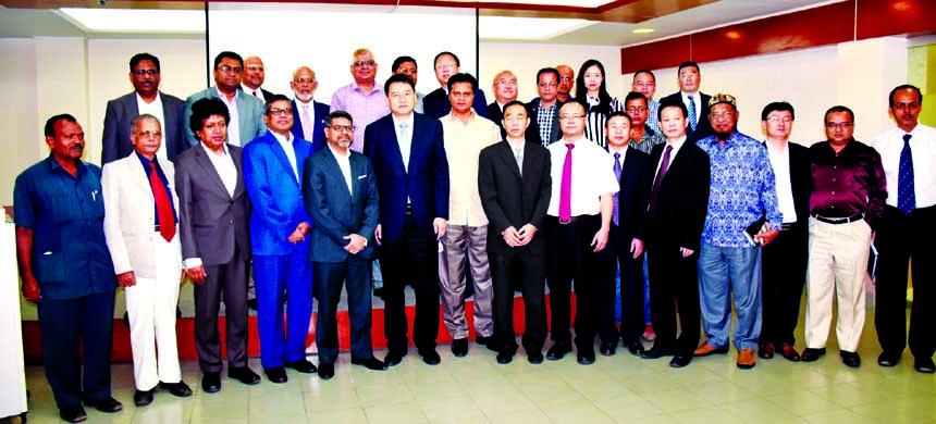 Visiting trade delegation from Yunnan Provincial Federation of Industry and Commerce of China and DCCI leaders pose after a bilateral meeting in the city on Monday. Hossain Khaled, President DCCI and Yu Dingcheng, head of Chinese delegation are seen in th