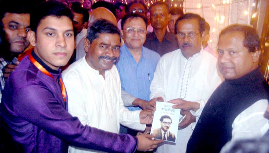 Members of Bangabandhu and Jatiyo Char Neta Smriti Parishad handing over the book title Bangabandhu and his incomplete biography to former mninister and former Chairman of Awami Jubo League Jahangir Kabir Nanok and State Minister for Jute Mirza Azam MP o