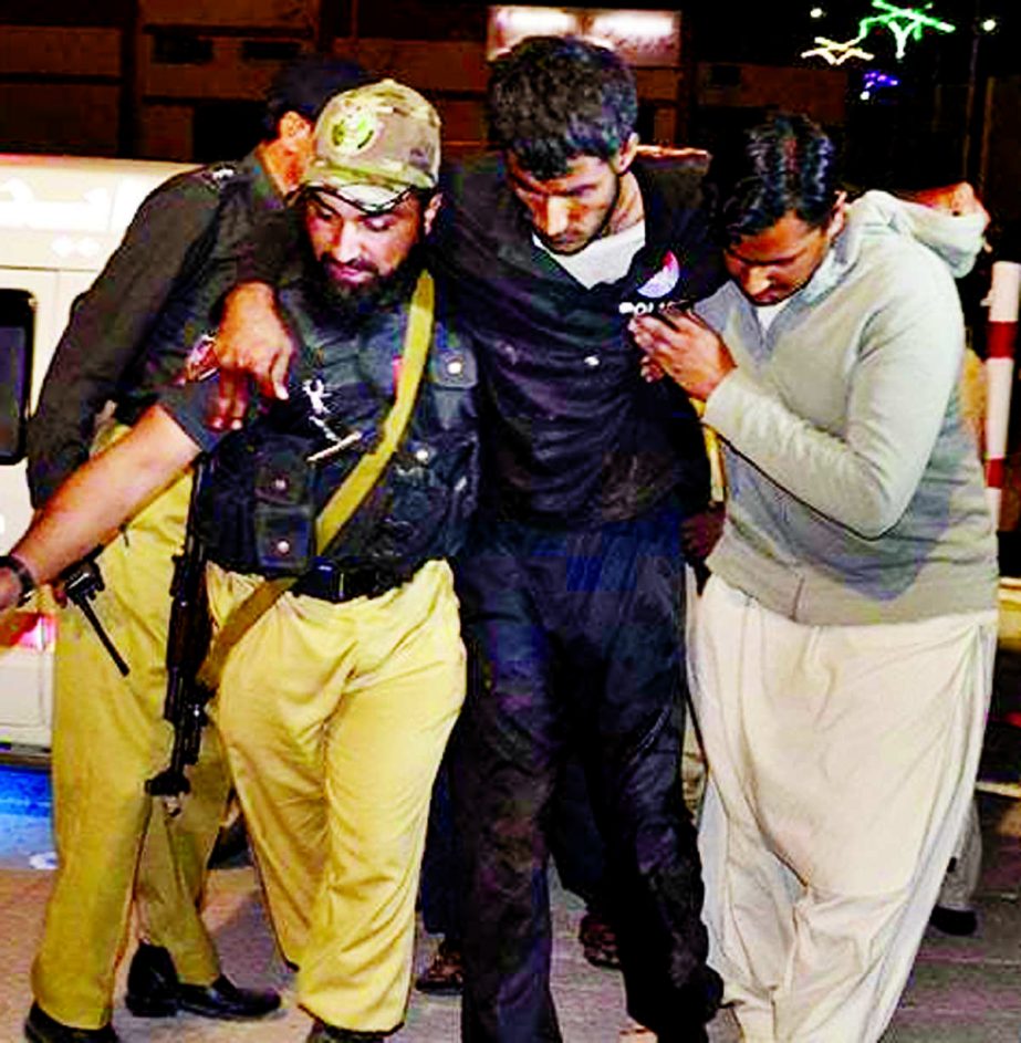 A volunteer and a police officer rush an injured person to a hospital in Quetta .