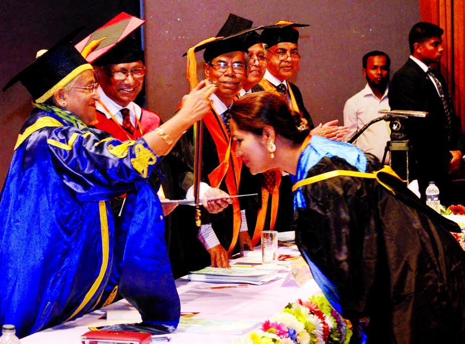 Prime Minister Sheikh Hasina distributing certificates, medals and fellowship among the students at the 13th Convocation Ceremony of BCPS at the Krishibid Institution auditorium on Wednesday. Dr. Ashrafunnesa receiving the awards.