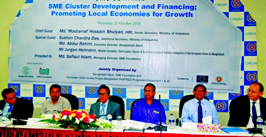 Mosharraf Hossain Bhuiyan, ndc, Senior Secretary of Ministry of Industry speaks at a seminar on 'SME Cluster Development and Financing; Promoting Local Economies for Growth' on Thursday in the city. Md Abidur Rahim, ED, Bangladesh Bank and Safiqul Islam