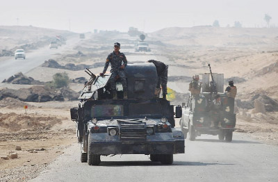 Iraqi forces gather near the village of Sin al-Dhuban, south of Mosul on Thursday, during an operation to retake the main hub city from Islamic State group jihadists