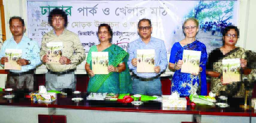 Regional Director of Health Bridge Debra Efroymson along with other distinguished persons holds the copies of a book titled 'Dhaka's Park and Playground' at its cover unwrapping ceremony organised by Health Bridge and Work for a Better Bangladesh Trust