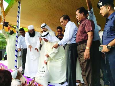 DOHAR( Dhaka) : Home Minister Asaduzzaman Khan Kamal distributing food and clothes among the poor people at Muksudpur Union under Dohahr Upazila organised by Kuwait Joint Relief Committee (KJRC) on Thursday.