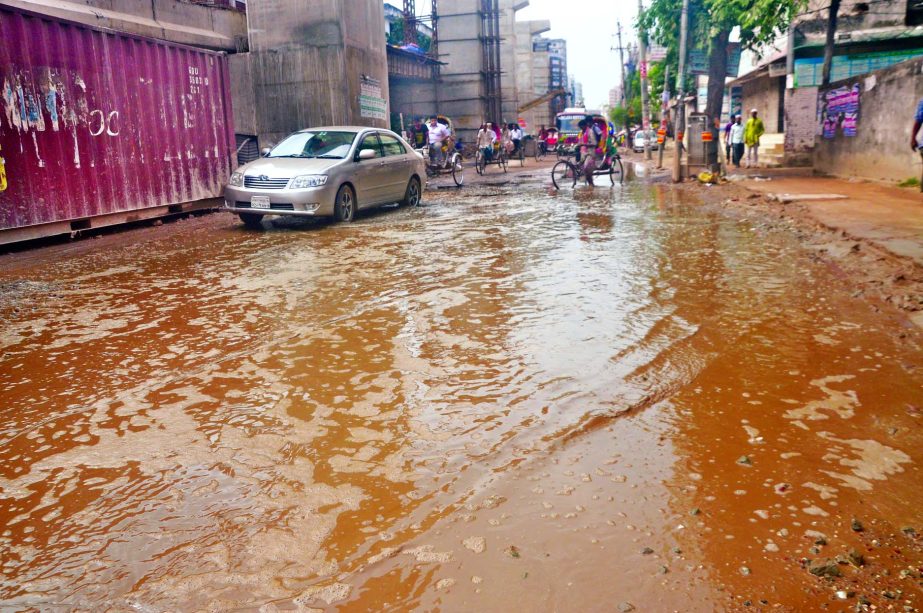 Rain and sewerage water remained stagnant on the road in Rajarbagh Police Line areas. Commuters have been suffering due to its dilapidated condition. This photo was taken on Saturday.