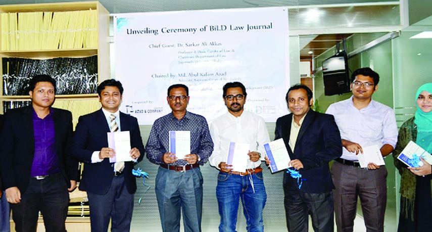 Chairman of Bangladesh Institute of Legal Development (BiLD) Abul Kalam Azad along with others holds the copies of its journal at its cover unwrapping ceremony in the city on Sunday.