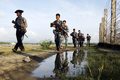 Myanmar police officers patrol along the border fence between Myanmar and Bangladesh in Maungdaw, Rakhine State, Myanmar..