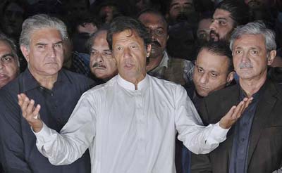 Politician Imran Khan speaks to journalists outside his residence in Islamabad, Pakistan.