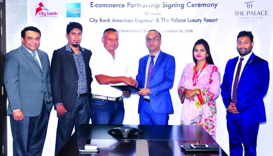 Mashrur Arefin, Additional MD and CCO of City Bank Ltd and Iqbal Ahmed, Chief Strategy Officer of Palace Luxury Resort, exchange documents after sign an agreement in the city recently. Senior officials of both organizations were also present in the signin
