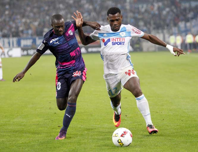 Bordeaux's defender Youssouf Sabaly (left) challenges Marseille's forward Bouna Sarr, during the League One soccer match between Marseille and Bordeaux, at the Velodrome stadium, in Marseille, southern France on Sunday.