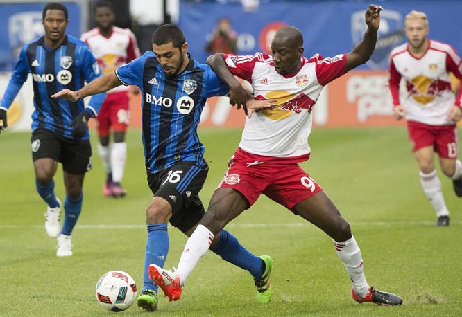 Montreal Impact's Victor Cabrera (left) challenges New York Red Bulls' Bradley Wright-Phillips during first-half action of the first leg of the Eastern Conference MLS soccer semifinal in Montreal on Sunday.