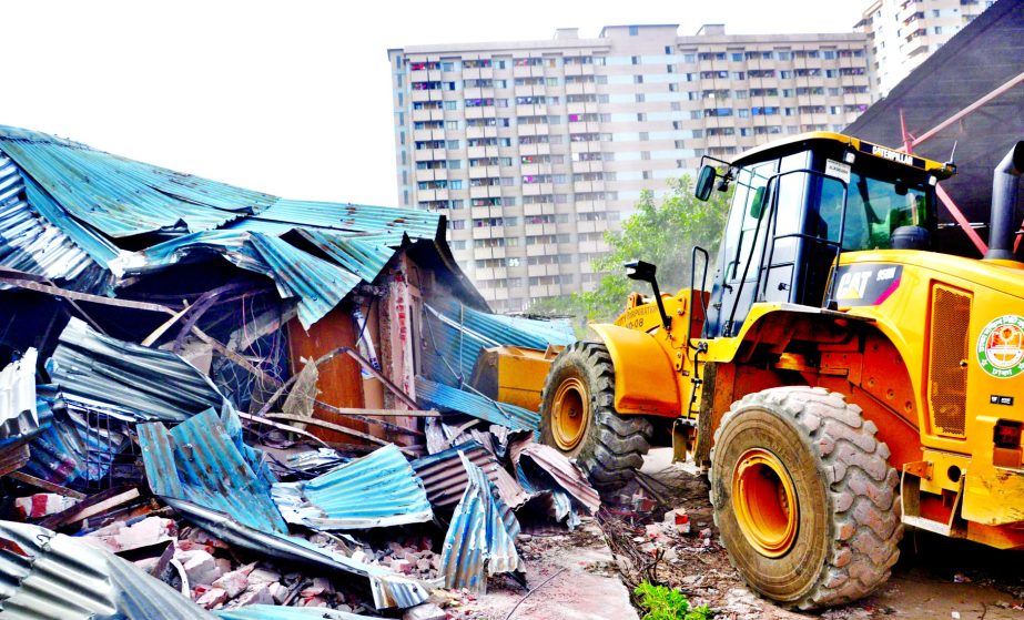Illegal structures owned by the local influential quarters at Dhalpur Playground were being bulldozed by Dhaka South City Corporation authority on Monday.