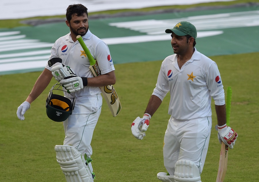 Pakistani batsmen Azhar Ali (L) and Sarfraz Ahmed walk back to the pavilion at the end of the third day of the third and final Test between Pakistan and West Indies at the Sharjah Cricket Stadium in Sharjah on Tuesday. Kraigg Brathwaite became the fifth W