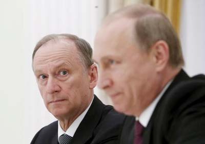 Russian Security Council Secretary Nikolai Patrushev (L) looks at President Vladimir Putin during a meeting with the BRICS countries' senior officials in charge of security matters at the Kremlin in Moscow, Russia