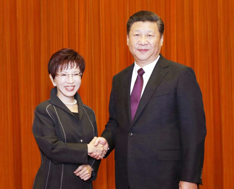 Chinese President Xi Jinping and Taiwan's Nationalist Party Chairwoman Hung Hsiu-chu shake hands as they pose for photographers during a meeting at the Great Hall of the People in Beijing on Tuesday.