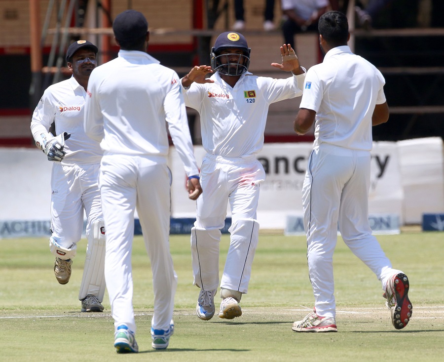 Sri Lanka's players celebrate a wicket during the fifth day of the Test cricket match between Sri Lanka and Zimbabwe at the Harare Sports Club in Harare, on Wednesday.This is Zimbabwe's 100th Test match since their international debut in 1992.