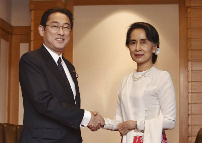 Myanmar State Counsellor and Foreign Minister Aung San Suu Kyi, shakes hands with Japan's Foreign Minister Fumio Kishida, (left) prior to their talks at a hotel in Tokyo on Thursday.