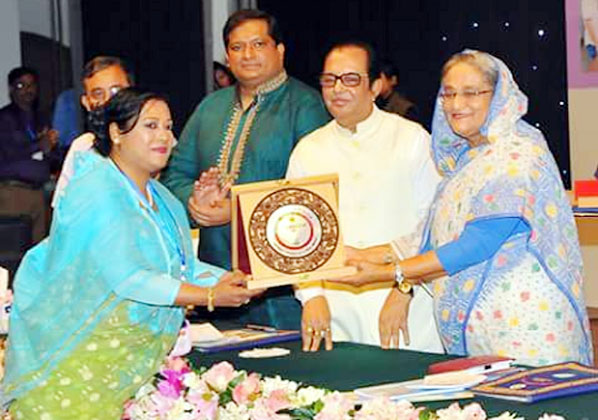 Founder President of Agrajattra- a social development organisation of Chittagong Neelima Akhter Chowdhury seen receiving the best Youth Organiser Award -2016 from Prime Minister Sheikh Hasina in Dhaka on Tuesday.