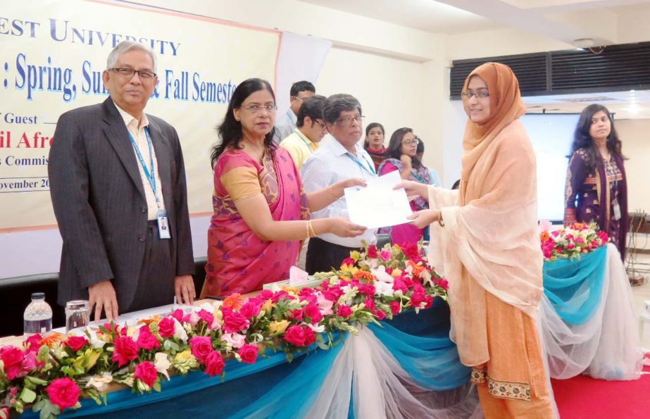 Prof Dr Dil Afroza Begum, Member, University Grants Commission of Bangladesh distributes certificates of Merit Scholarships among the students of East West University in a ceremony held EWU campus, Aftabnagar in the city on Sunday.