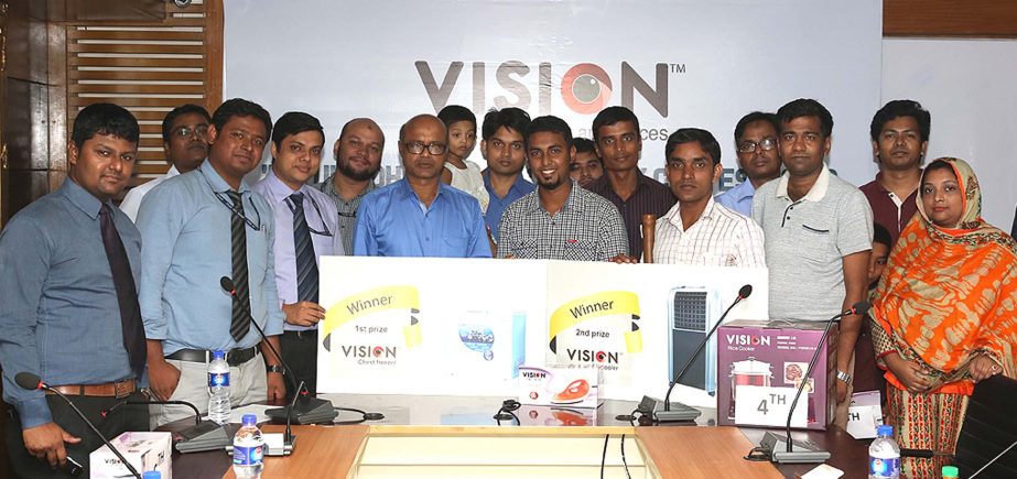 Rakib Ahmed, Brand Manager of Vision Electronics, handing over prizes among winners of 'Eid-ul-Azha sacrifice story contest' at PRAN-RFL Center in the city recently. Azim Hossain, Head of Digital Media of PRAN-RFL Group and Sabbir Ahmed, CEO of Bazooka