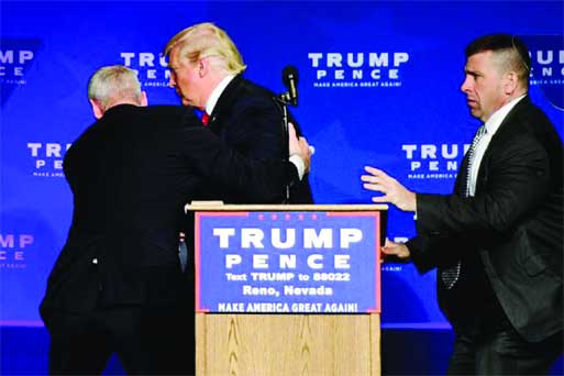 US Republican presidential nominee Donald Trump is hustled off the stage by security agents after a perceived threat in the crowd, at a campaign rally in Reno, Nevada, US. Internet photo