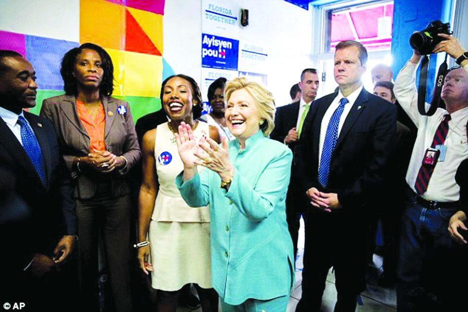 Hillary Clinton greeted people at a stop in Miami's Little Haiti as she tries to motivate her supporters to vote on Saturday.