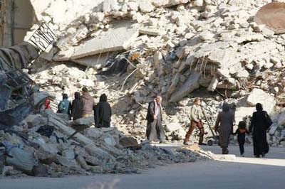 People walk past rubble of damaged buildings in a rebel-held besieged area in Aleppo, Syria on Sunday.