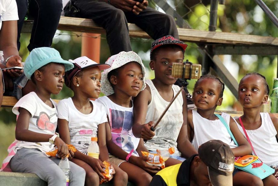 Children take a selfie on the first day of the second test cricket match between Zimbabwe and Sri Lanka at Harare Sports Club in Harare on Sunday. Zimbabwe is playing its 100th Test cricket match as it hosts Sri Lanka in Zimbabwe.