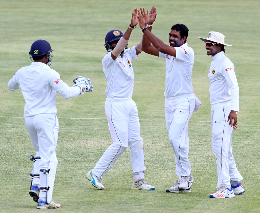 Sri Lanka bowler Dilruwan Perera (2ndR) celebrates a wicket on the third day of the second cricket Test match between Sri Lanka and Zimbabwe at Harare Sports Club on Tuesday.