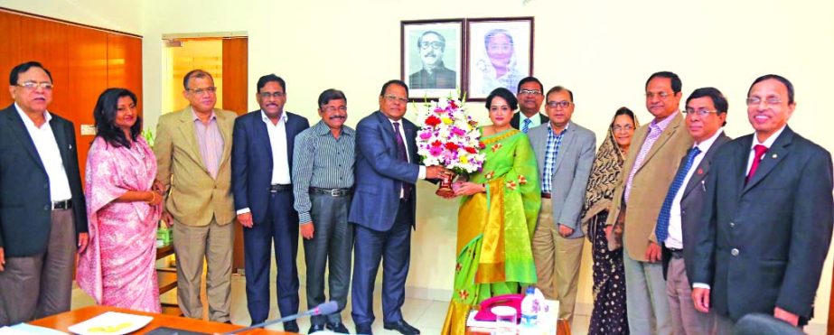 Shaikh Md Wahid-uz-Zaman, Chairman of Janata Bank Ltd congratulates Selima Ahmad, newly appointed director of the bank on behalf of the Board of Directors on Tuesday at the banks head office in the city. Md Emdadul Hoque, AKM Kamrul Islam, FCA, Md Mahabub