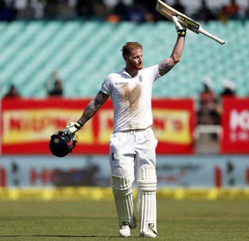 England's batsman Ben Stokes raises his bat after scoring hundred during the second day of the first Test cricket match between India and England in Rajkot, India, Thursday.