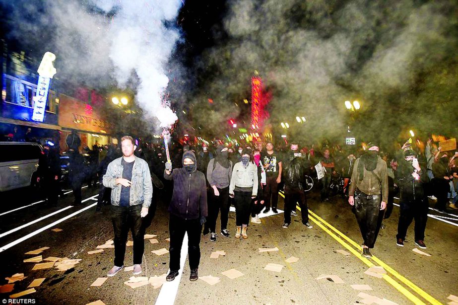 A protester shoots fireworks at police officers during rioting in Oakland, California, on Wednesday.