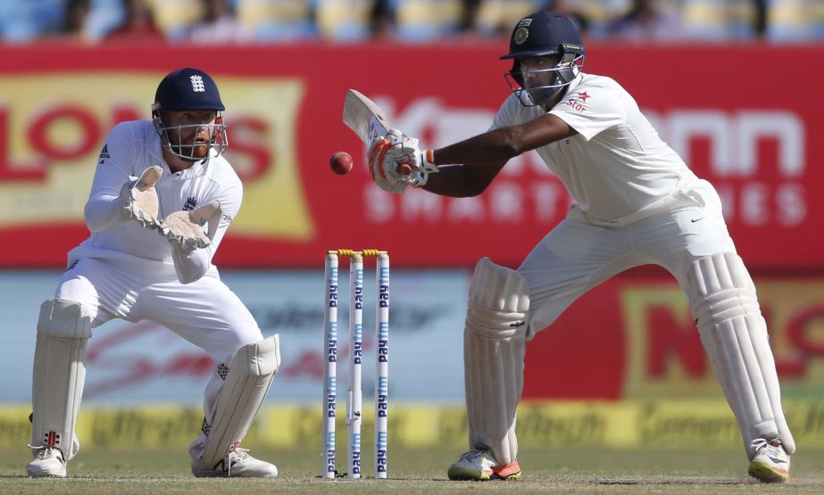 England's cricket captain Alastair Cook (right) bats on the fourth day of the first cricket Test match between India and England in Rajkot, India on Saturday.