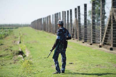 A military officer patrols the border fence along the river dividing Myanmar and Bangladesh located in Maungdaw, Rakhine State where there has been an upsurge of violence since October.