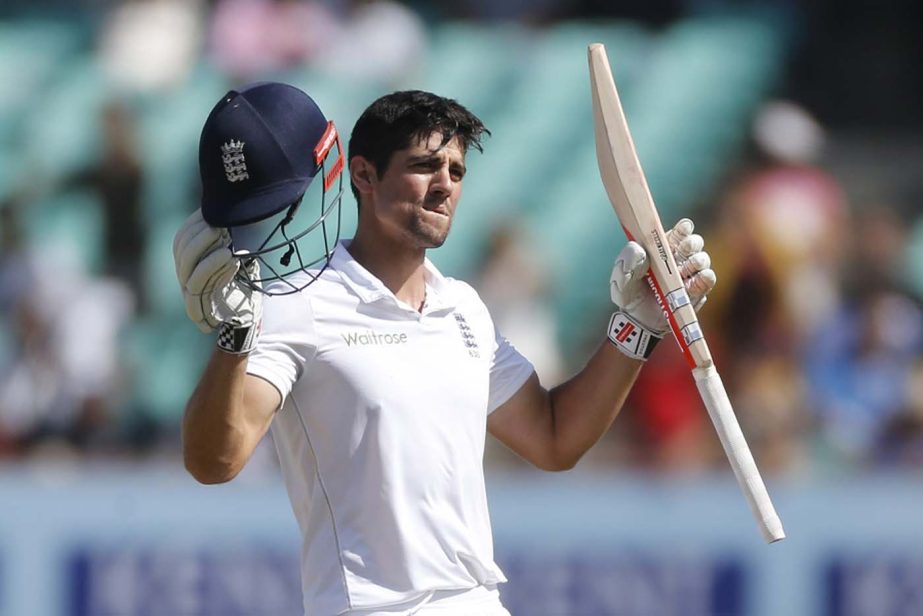 England's cricket captain Alastair Cook raises his bat and helmet after scoring century on the fifth day of the first cricket Test match between India and England in Rajkot, India on Sunday.