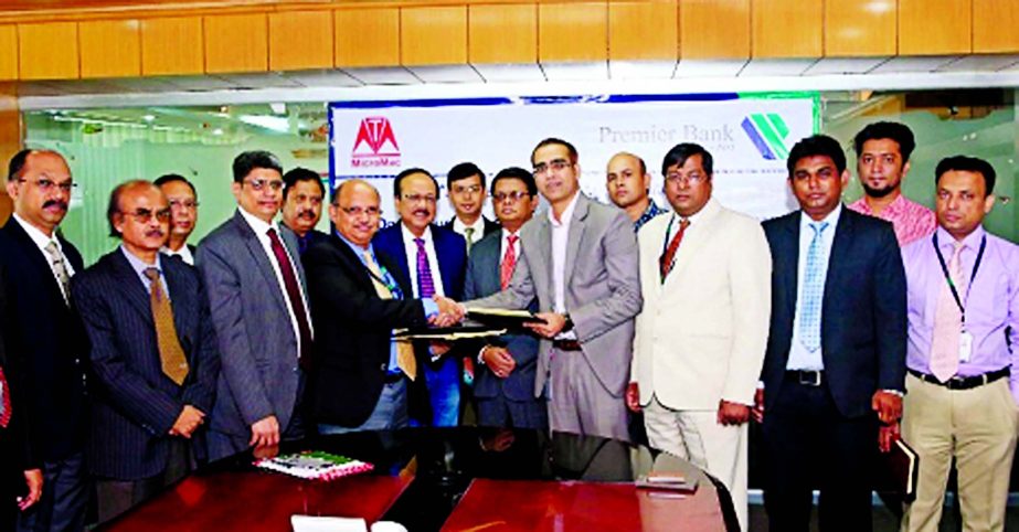 Syed Nowsher Ali, Deputy Managing Director of Premier Bank Ltd and Engr. Anisur Rahman, Managing Director and CEO, MicroMac Tech Valley Ltd exchanging documents after signing an agreement on eDoc: Security Document Management System Software in the city o