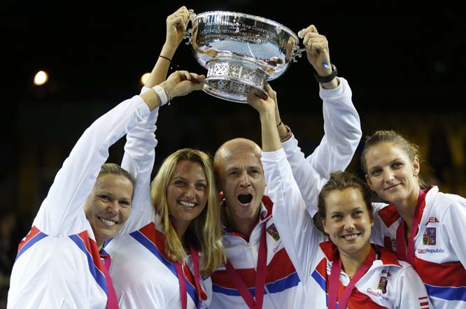 Czech Republic team captain Petr Pala, center, and players lift the trophy after their victory against France, during the Fed Cup final in Strasbourg, eastern France on Sunday. Czech Republic retains Fed Cup title by beating France 3-2.