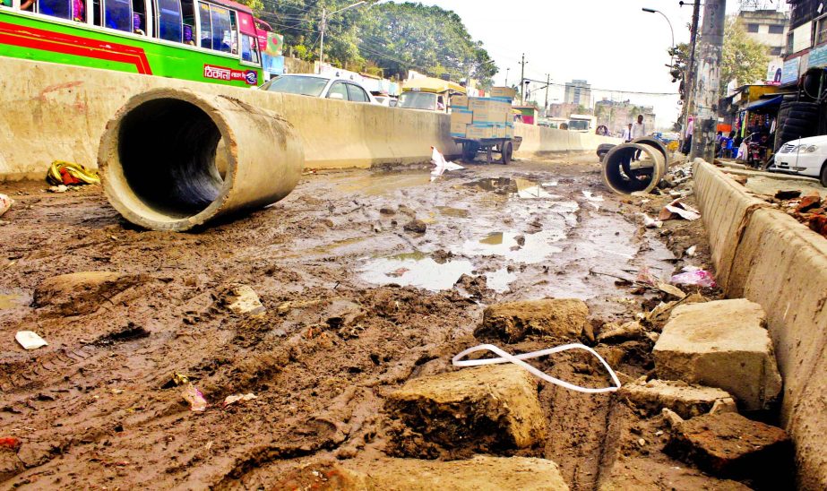 The main thoroughfare in front of new building of Dhaka Medical College Hospital near Hanif flyover is in dilapidated condition causing sufferings to commuters and patients. This photo was taken on Tuesday.