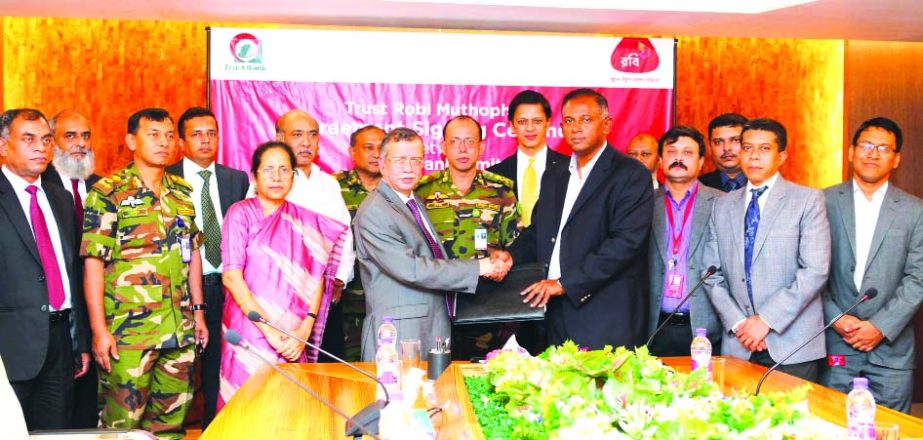 Ishtiaque Ahmed Chowdhury, MD and CEO of Trust Bank Ltd (TBL) and Mahtab Uddin Ahmed, MD and CEO of Robi exchanging documents after signing a corporate agreement on Wednesday in the city. Major General S M Matiur Rahman, afwc, psc Adjutant General, Bangla