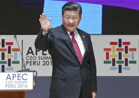 China's President Xi Jinping waves after speaking at the CEO summit during the annual Asia Pacific Economic Cooperation (APEC) forum in Lima, Peru on Saturday.