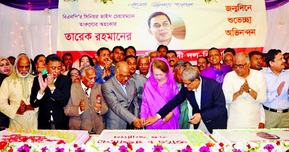 BNP Chairperson Begum Khaleda Zia along with her party colleagues cutting cake marking birthday of her son and the party's Senior Vice-Chairman Tarique Rahman at her party office in the city on Sunday.