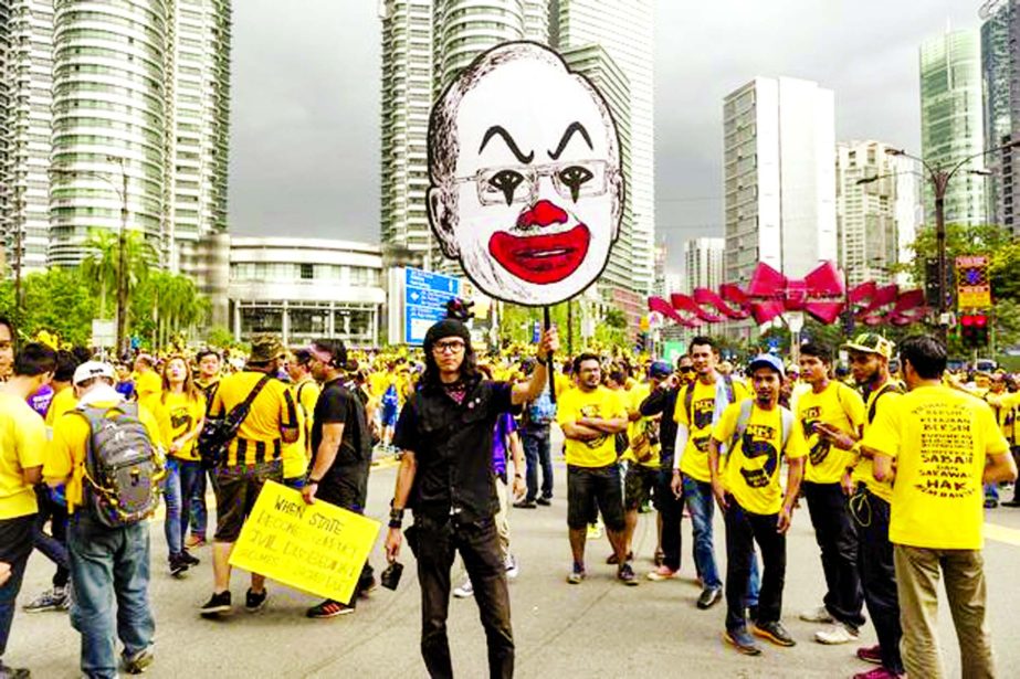 A protester holds up a large caricature of Prime Minister Najib Razak during the Bersih rally in Kuala Lumpur on Saturday.