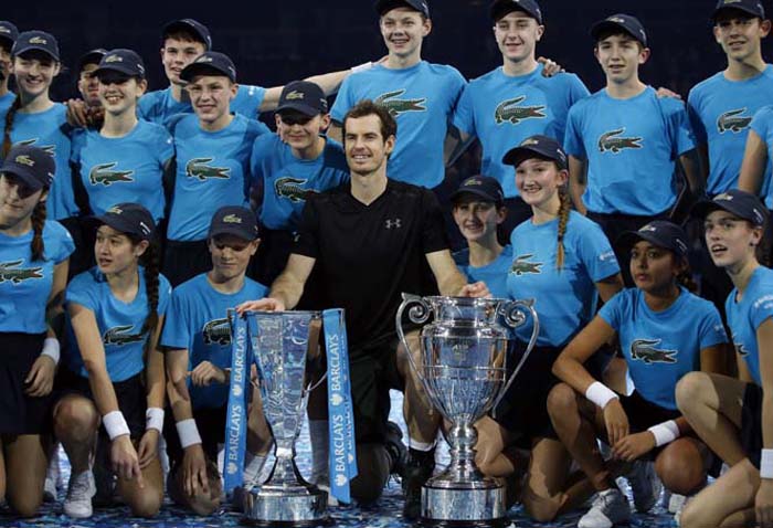 Andy Murray of Britain poses with his trophies after winning the ATP World Tour Finals singles final tennis match against Novak Djokovic of Serbia at the O2 Arena in London on Sunday.