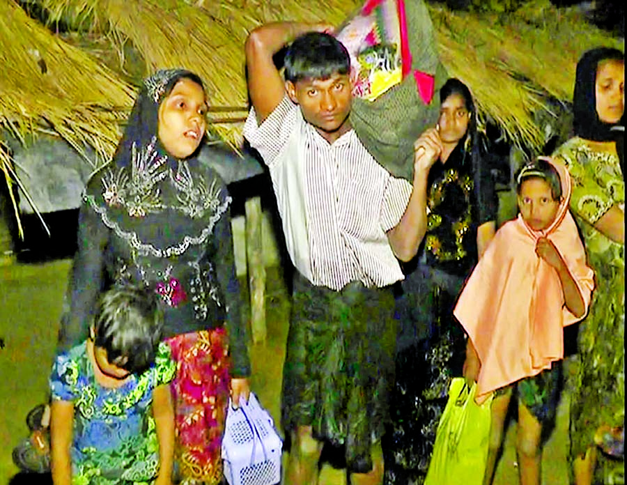 Desperate bid to flee Rohingya Muslim families seen entering Teknaf in Cox's Bazar crossing Naf River defying BGB's high alertness at Myanmar border. This photo was taken on Monday.