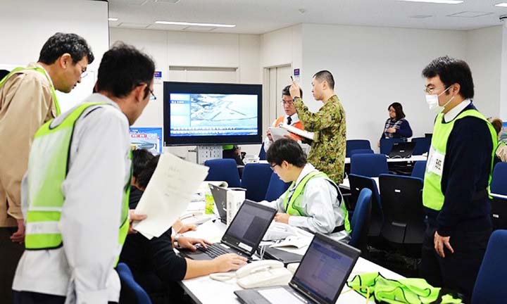 Officers at the Fukushima prefectural office gather data following an earthquake that hit the prefecture on Tuesday.