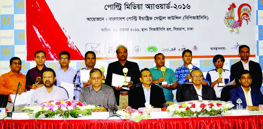BFUJ President Monjurul Ahsan Bulbul seen with the recipients of Poultry Media Awards at a function at CIRDAP Auditorium in the city yesterday.